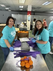 Team members assisting at Naples 'Gives Back' event