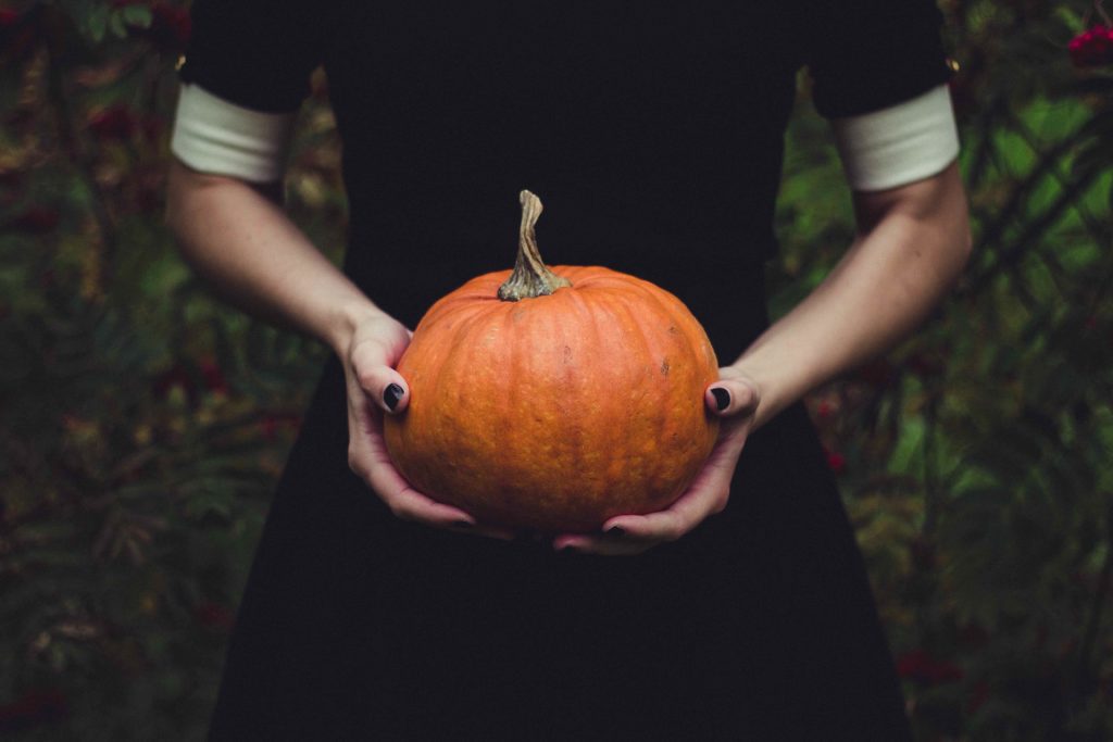 girl holding pumpkin