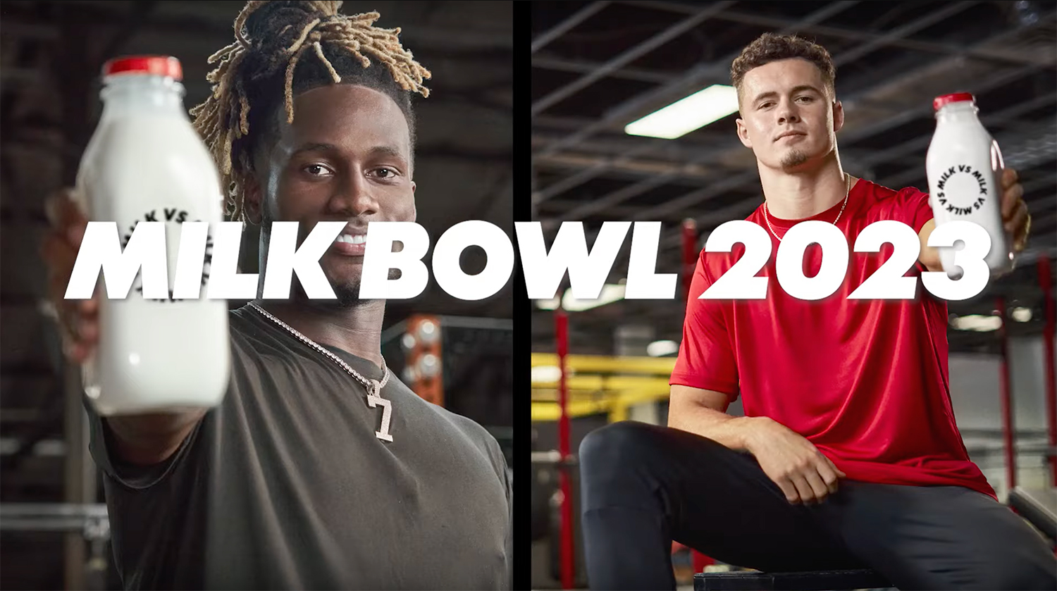 Milk bowl two college athletes holding glass milk bottles close to the camera