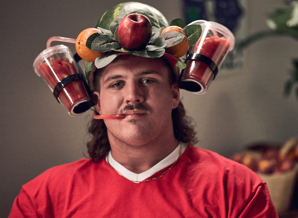 Georgia Fruit and Vegetable Growers Association Tate Ratledge NIL college athlete wearing a fruit smoothie hat