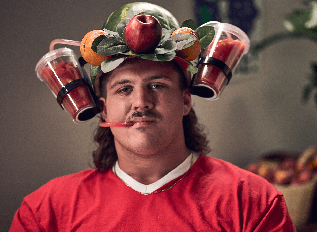 Georgia Fruit and Vegetable Growers Association Tate Ratledge NIL college athlete wearing a fruit smoothie hat