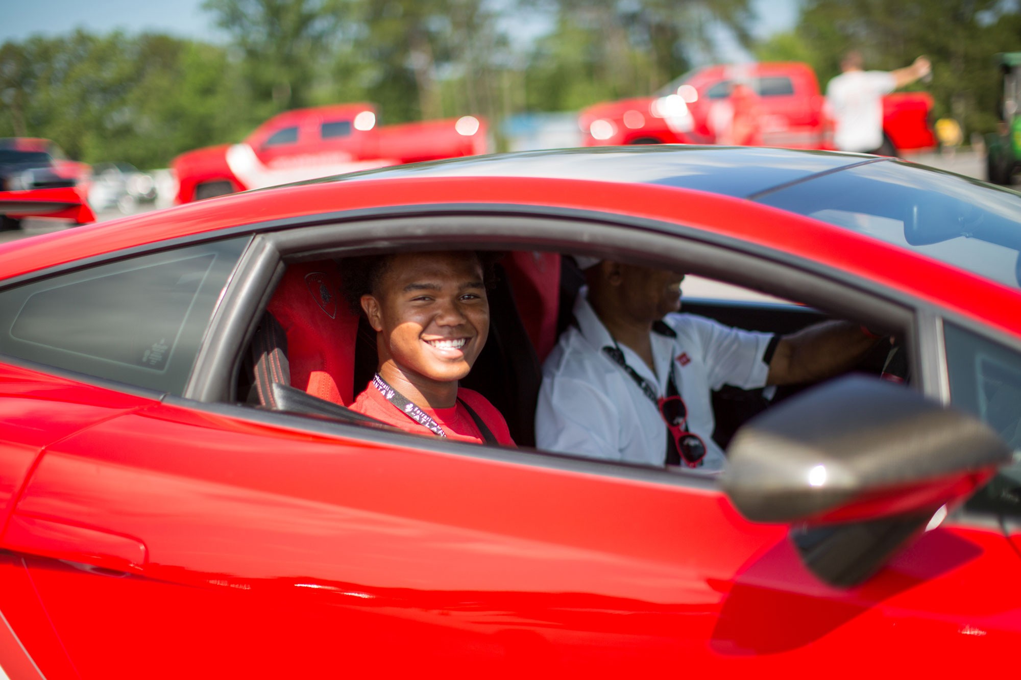 rides to remember teenage boy smiling from the passenger seat of a red car
