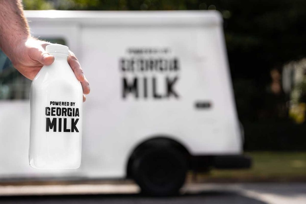 powered by georgia milk stetson bennett campaign milk close to camera with milk truck in background