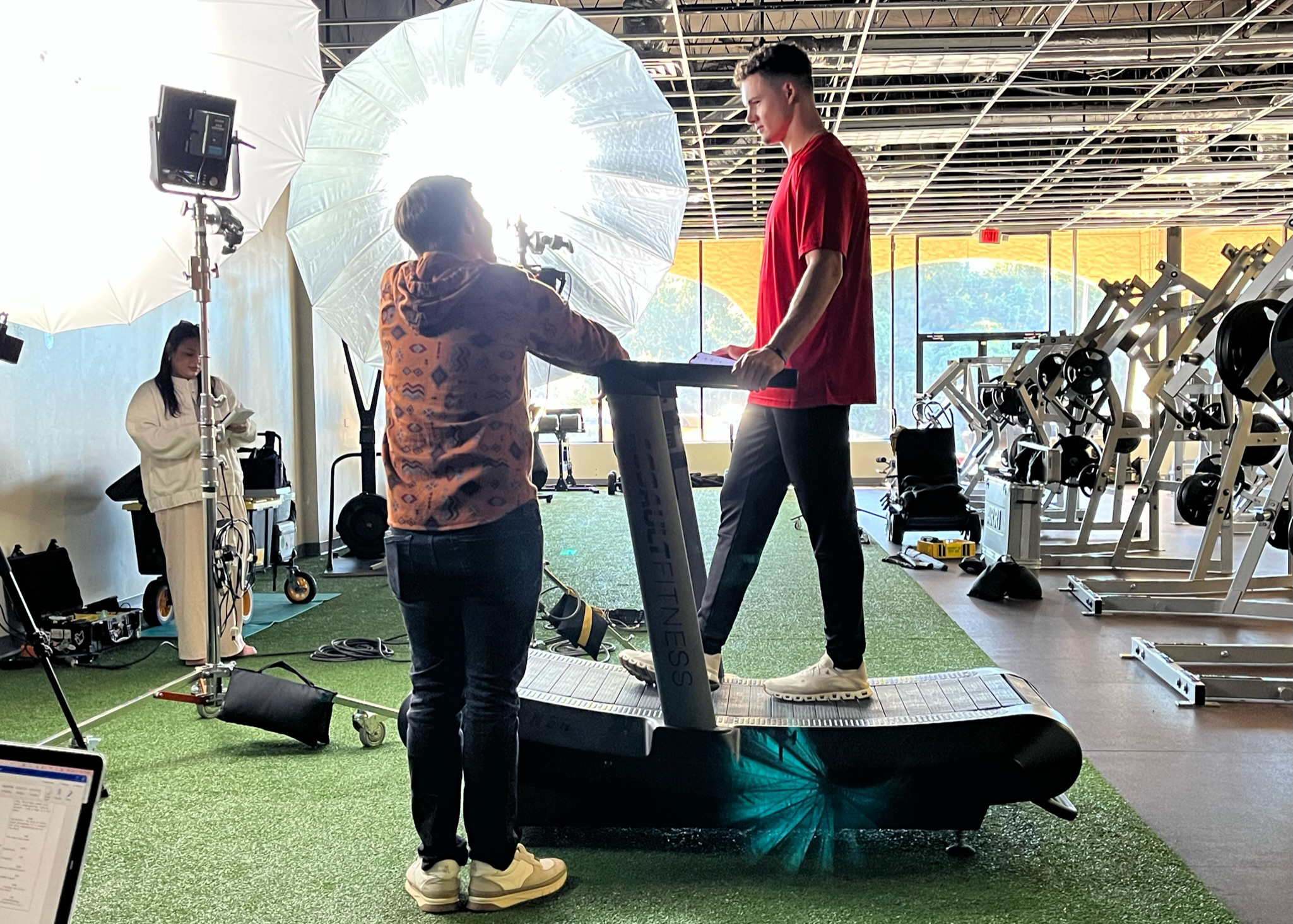 MOMM video shoot college athlete on a treadmill with studio lights