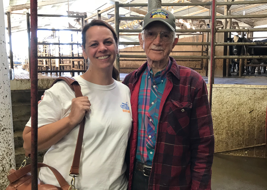 woman and older man posing in a milking parlor Lisa Perrin Dubravec Johnny Walker