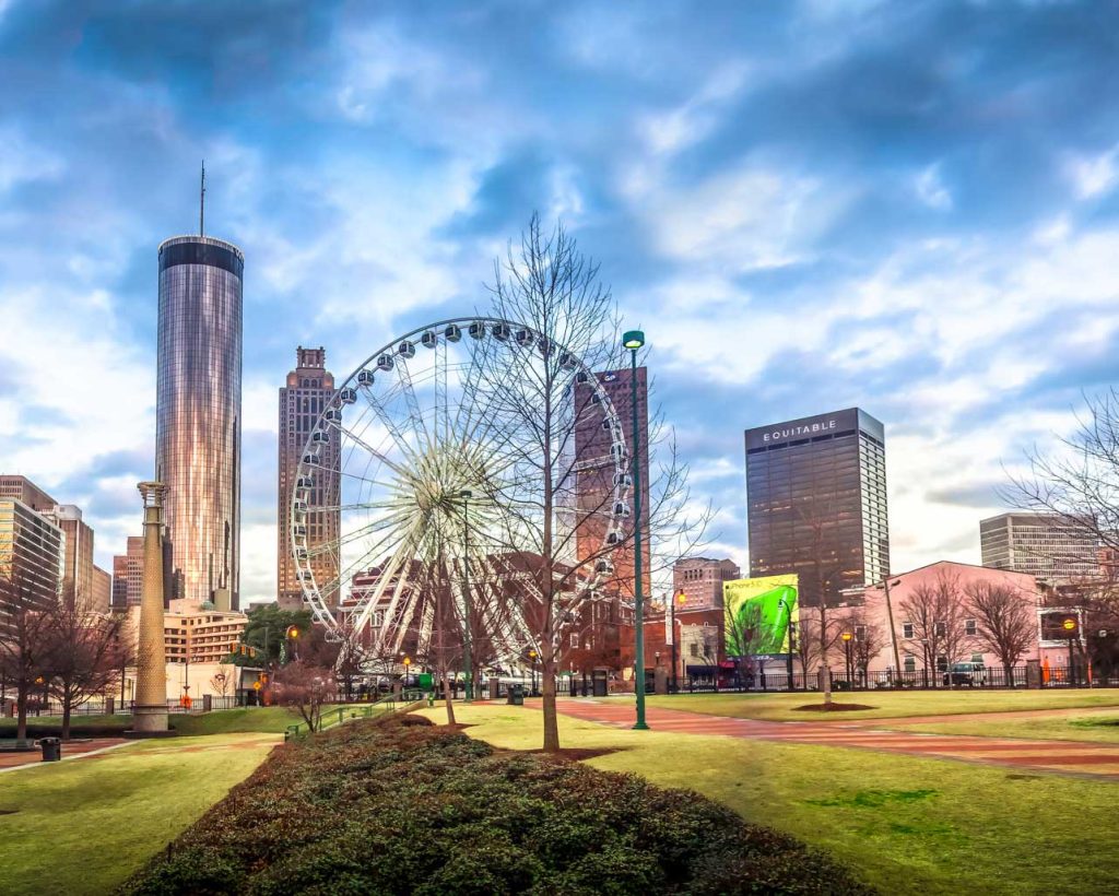 Centennial park ferris wheel in front of atlanta buildings
