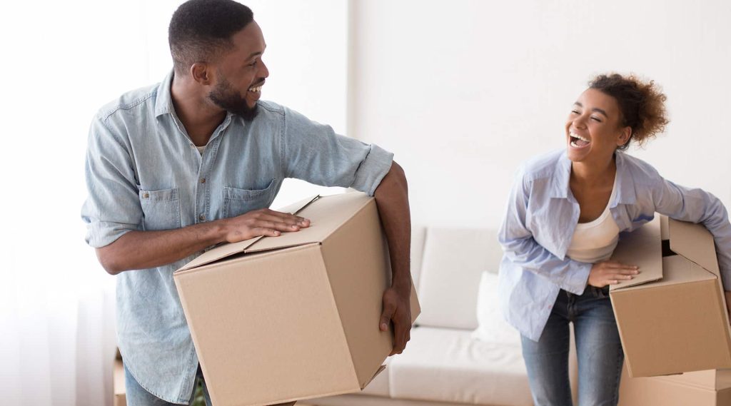 Mercy health a young couple looking at each other with moving boxes