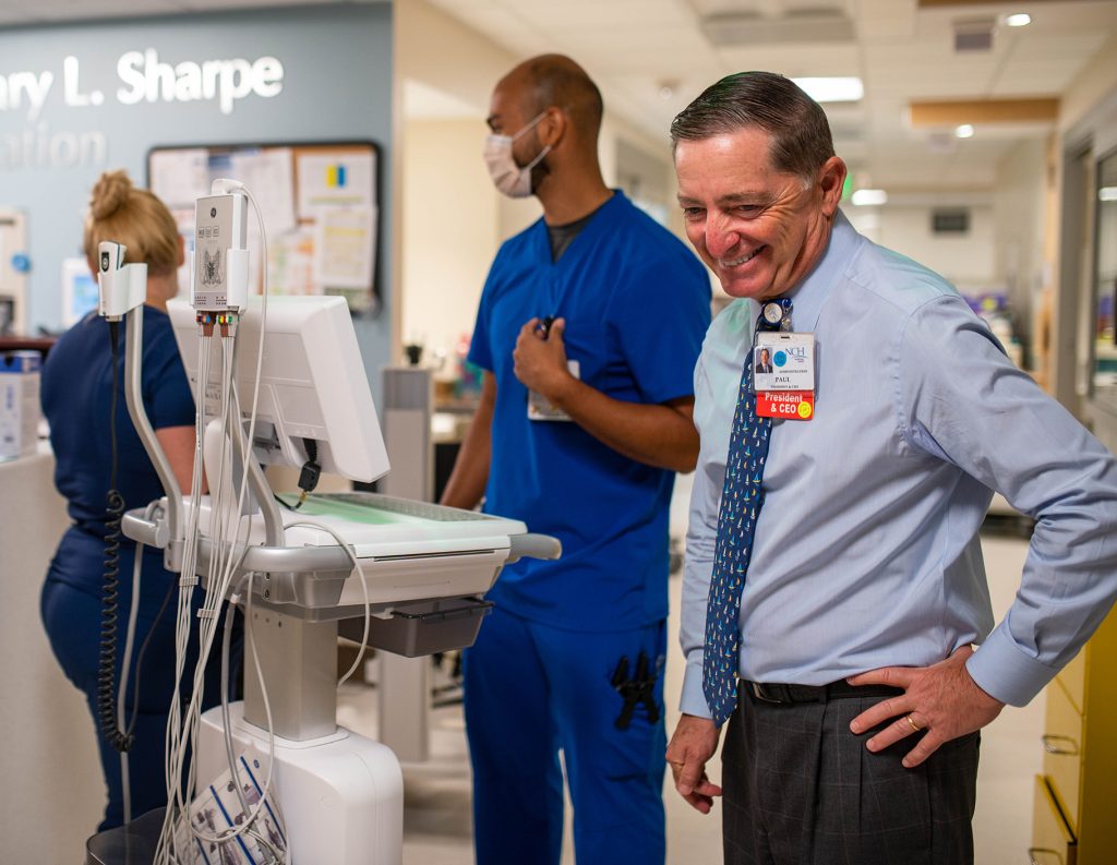 nch paul hiltz on the nurse floor with two nurses in the background