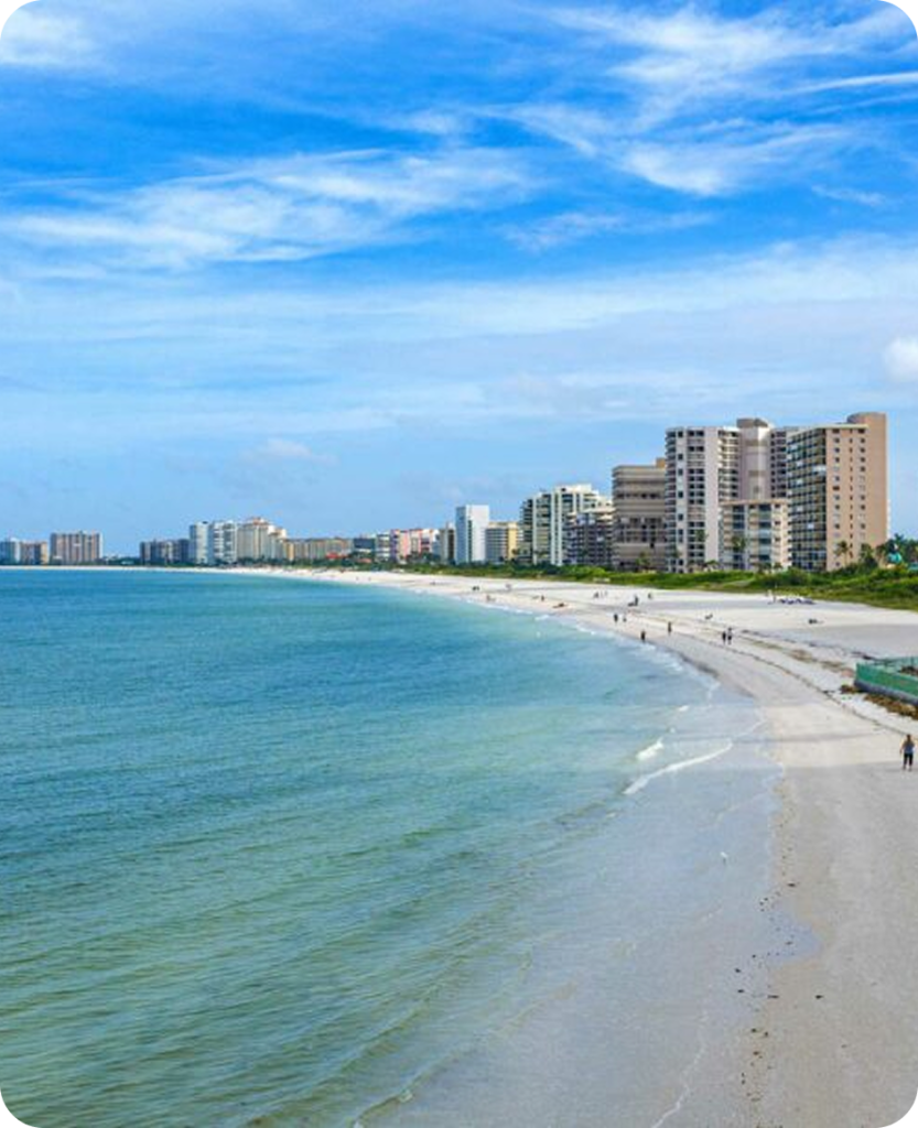 a beach with buildings and water